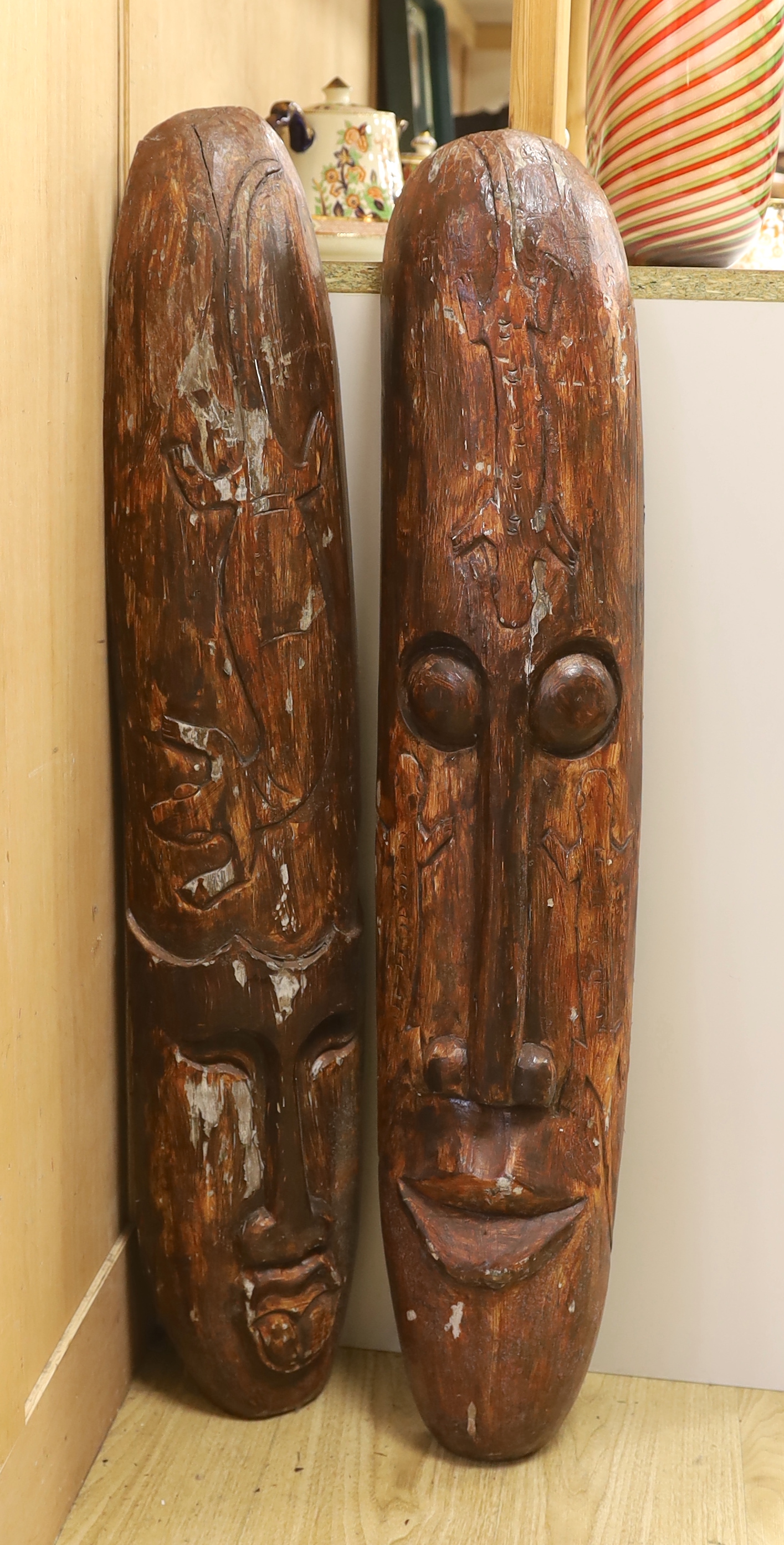 A pair of tribal style masks, 98.5cm